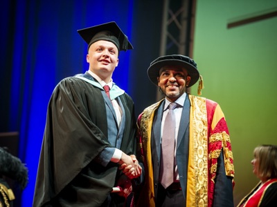 graduate shaking hands