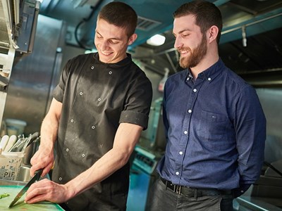 two people in a kitchen