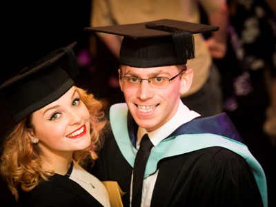 graduates look up at camera