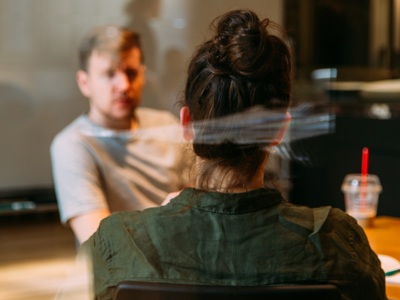 two people sitting opposite each other at a table
