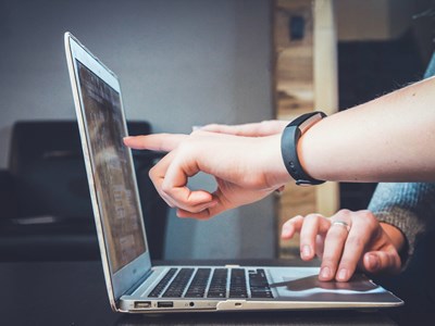 people typing on laptop