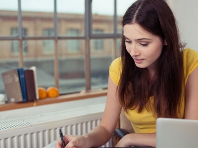 person sitting, writing