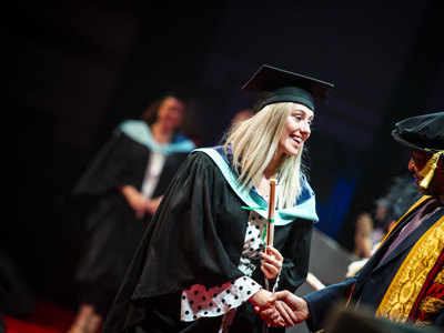 graduate receiving scroll