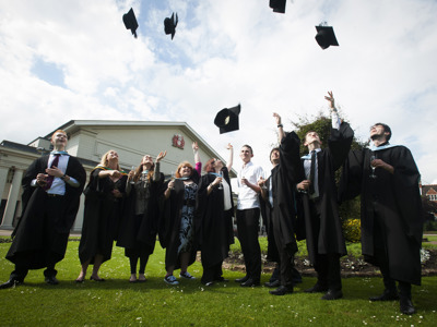 graduates throwing caps in the air
