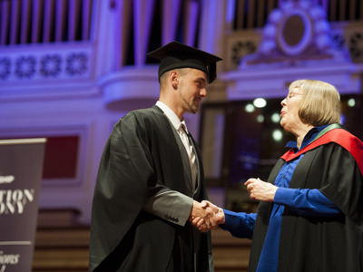 graduate shaking hands with presenter