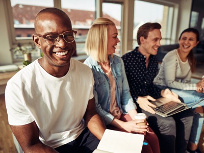 four people smiling