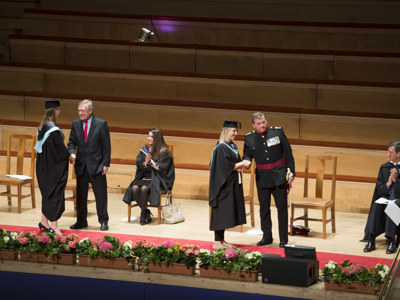 graduates receiving awards on stage