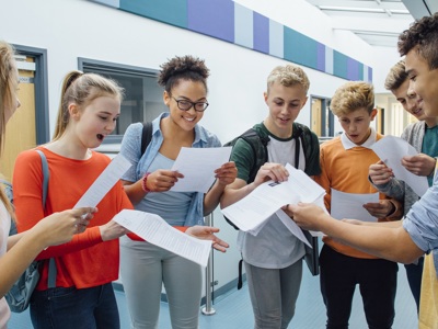 group of young people looking at exam results