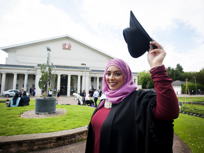 graduate smiling outside de montfort hall