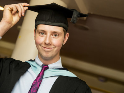 graduate holding cap